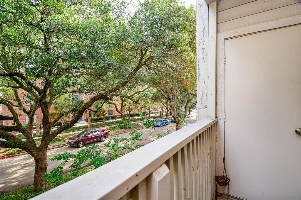 This unit overlooks a quiet street, lined with mature oak trees.