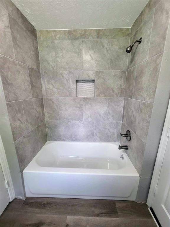 Attractive tub/shower combo with new tile & built in shelf for added storage