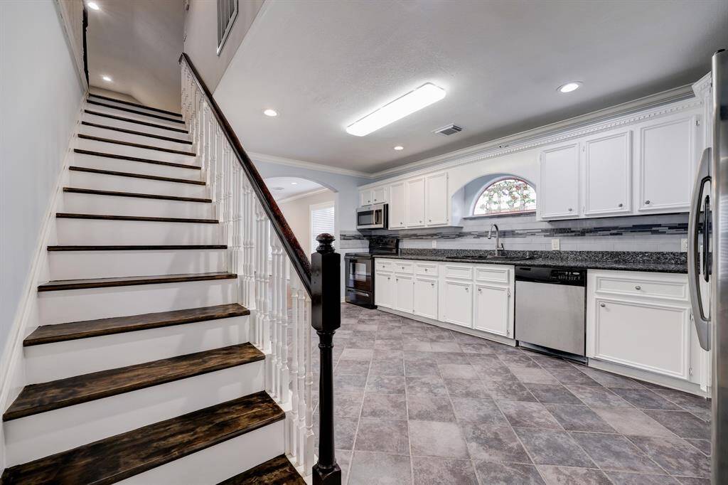 Stairs leading to the bonus room and w/d hookups