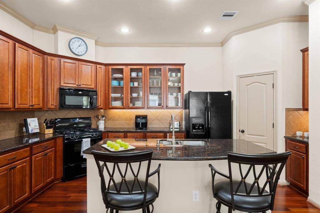 Kitchen island with seating overlooks the heart of the home, creating an ideal setting for casual gatherings.
