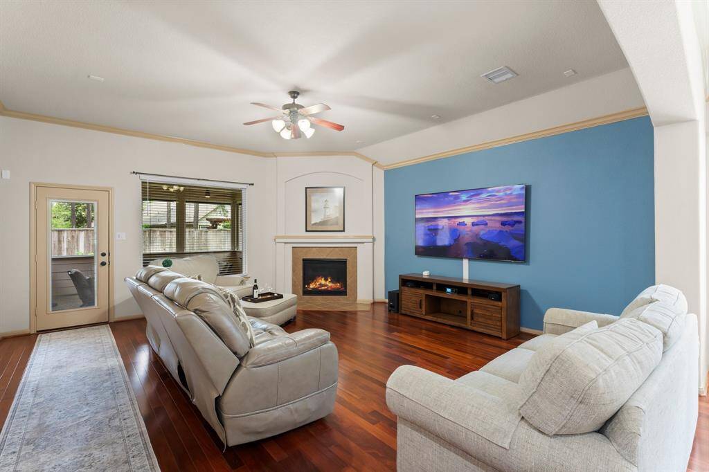 Inviting living room with fireplace and large picture windows that fill the space with natural light.