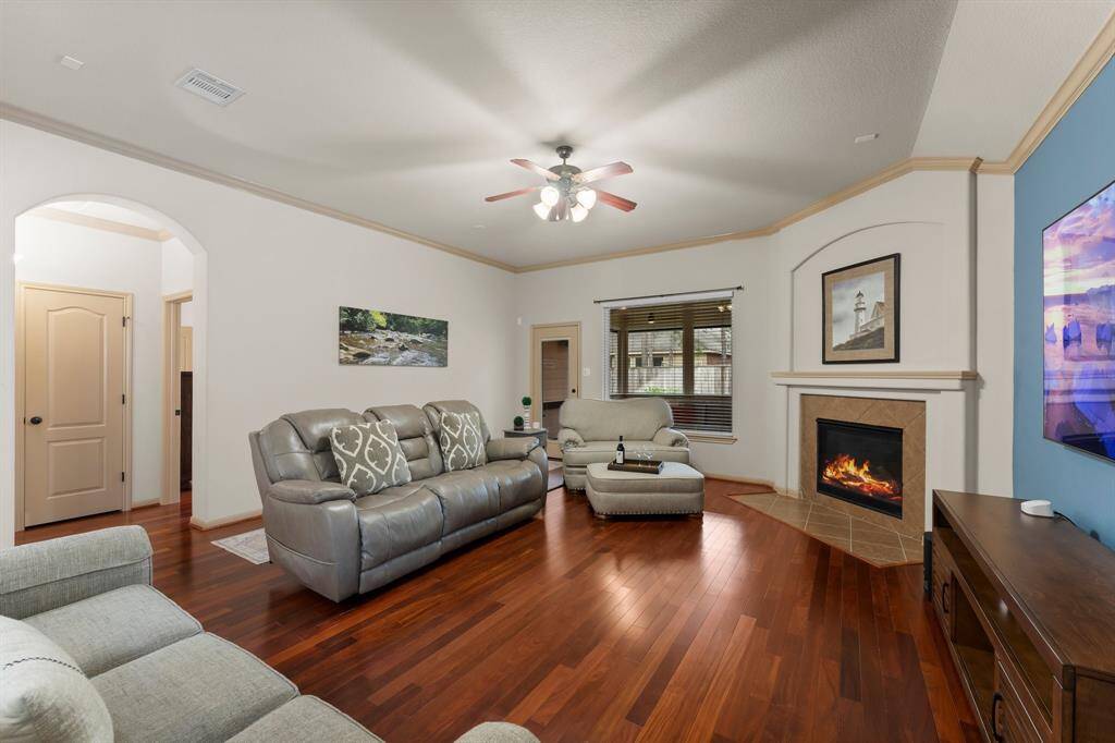 A spacious layout offers ample room for relaxation and entertaining, framed by arched doorways and natural light.