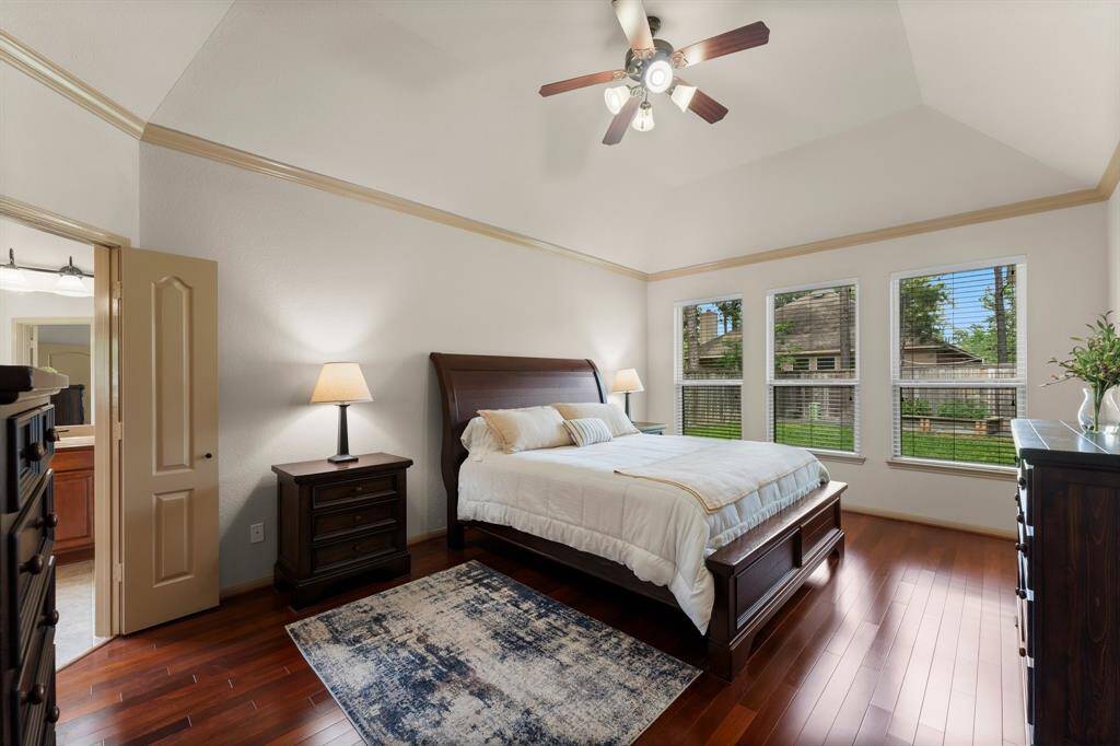 Retreat to the expansive primary suite featuring soaring ceilings, oversized windows, and serene backyard views.