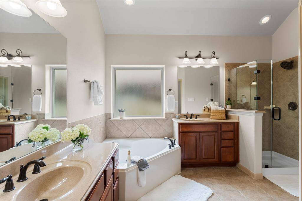 Thoughtfully designed for comfort and style, this serene retreat boasts newly installed mirrors and sleek glass shower enclosure