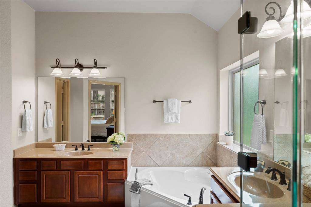Elegant and refreshed with brand new mirrors and frameless shower glass, this space blends functionality with timeless design.