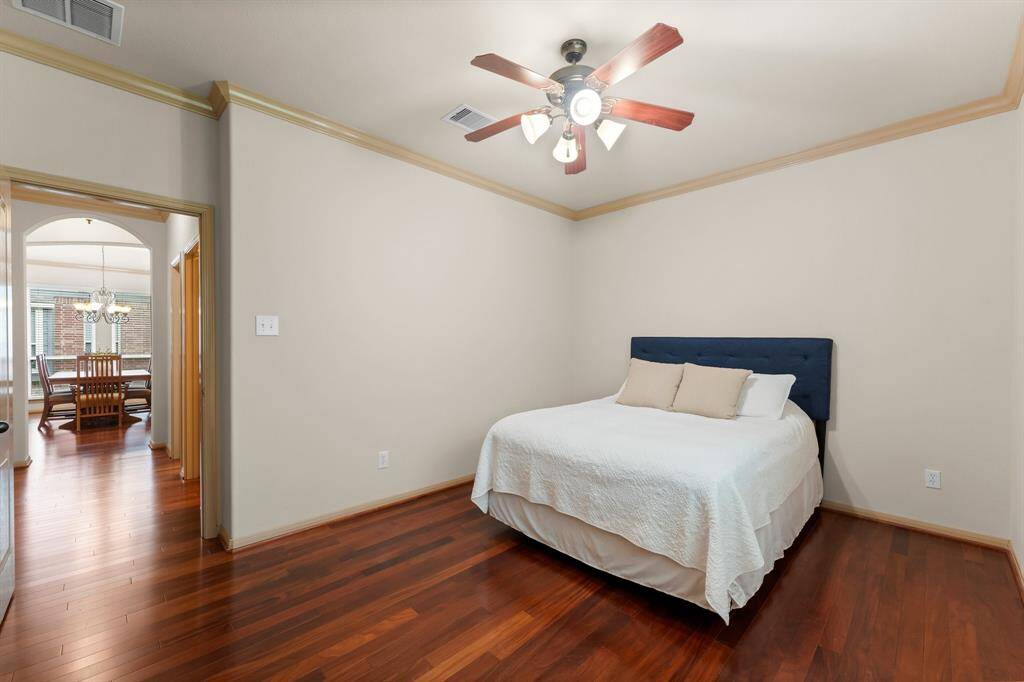 Another angle of the same bedroom showcasing the connection to the hallway and dining room beyond