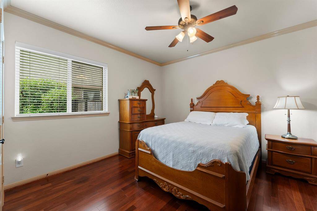 Beautifully appointed guest bedroom with ample space, hardwood floors, large closet and a peaceful view.