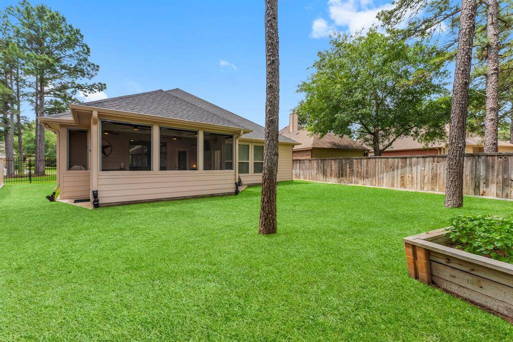 The expansive backyard features lush landscaping and plenty of space for play, pets, or a future pool—surrounded by a privacy fence and mature trees for a serene setting.