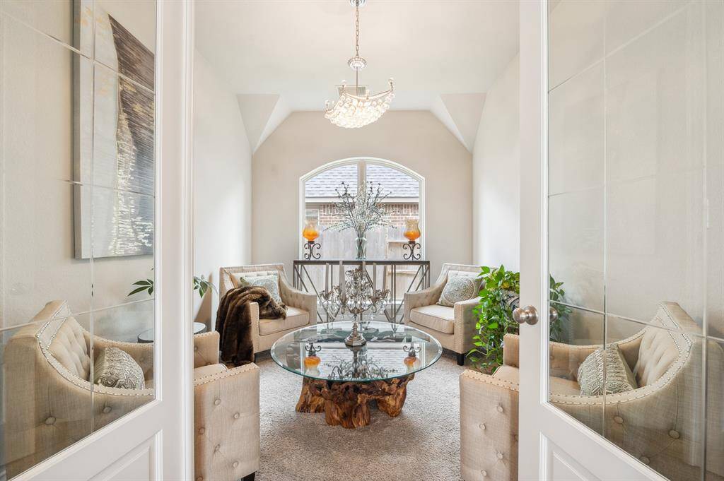 This versatile flex space, currently serving as a formal living room, with high ceilings and windows that flood the room with natural light. Its open layout and elegant design offer endless possibilities.