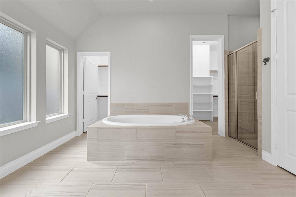 Your master bathroom with a double walk in closet, soaking tub and separate shower/toilet.