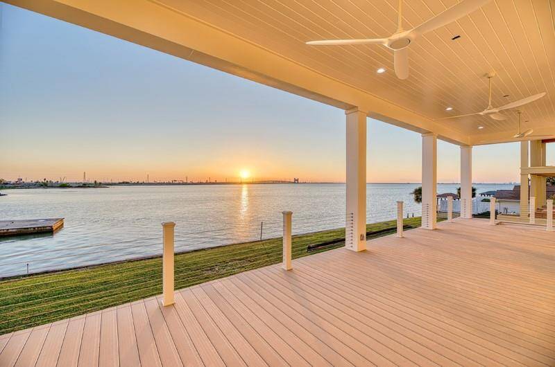 Enjoy breathtaking sunsets from this spacious, covered deck, complete with ceiling fans for added comfort.