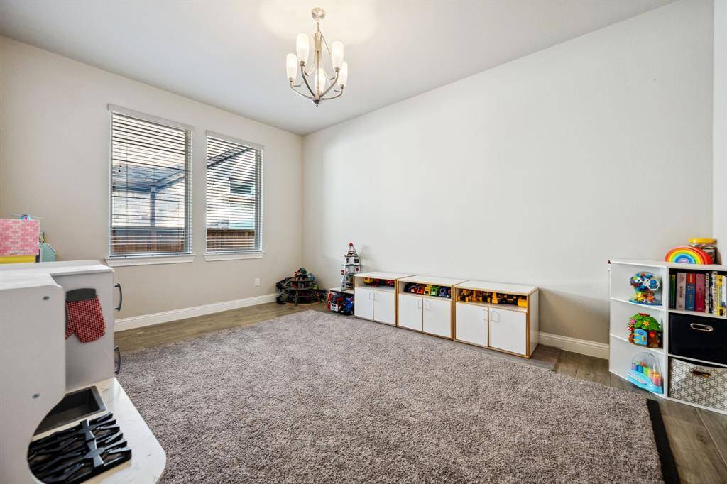 dining room/flex room. Using a carpet rug, there is wood like tile in the room underneat the rug.