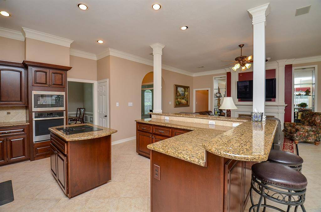 Striking column detail distinguishes kitchen areas from combined living space.  Numerous cabinet storage.