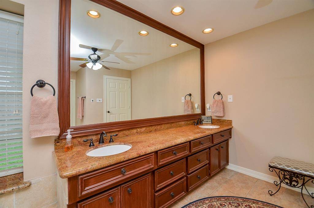 Magnificent luxury fills your primary ensuite bath, with warm wall tones and spectacular space. Ample drawers for all your storage needs.