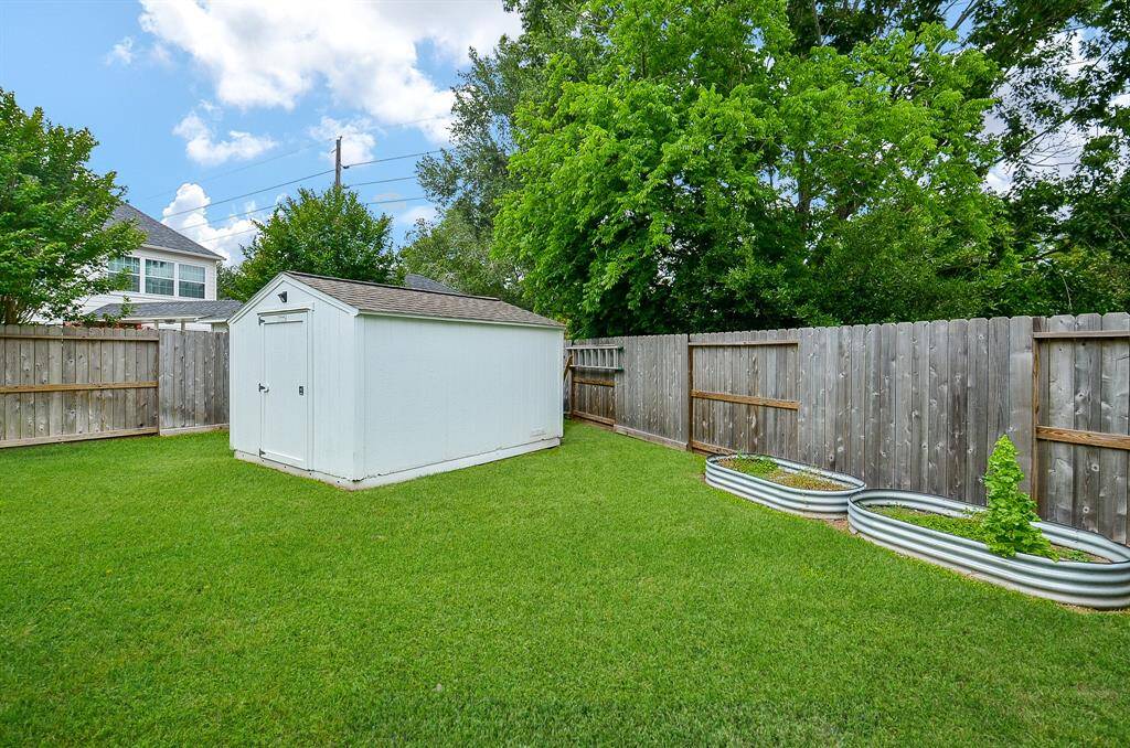 Garden beds encourage your green thumb, while a trusty utility shed houses outdoor gear.