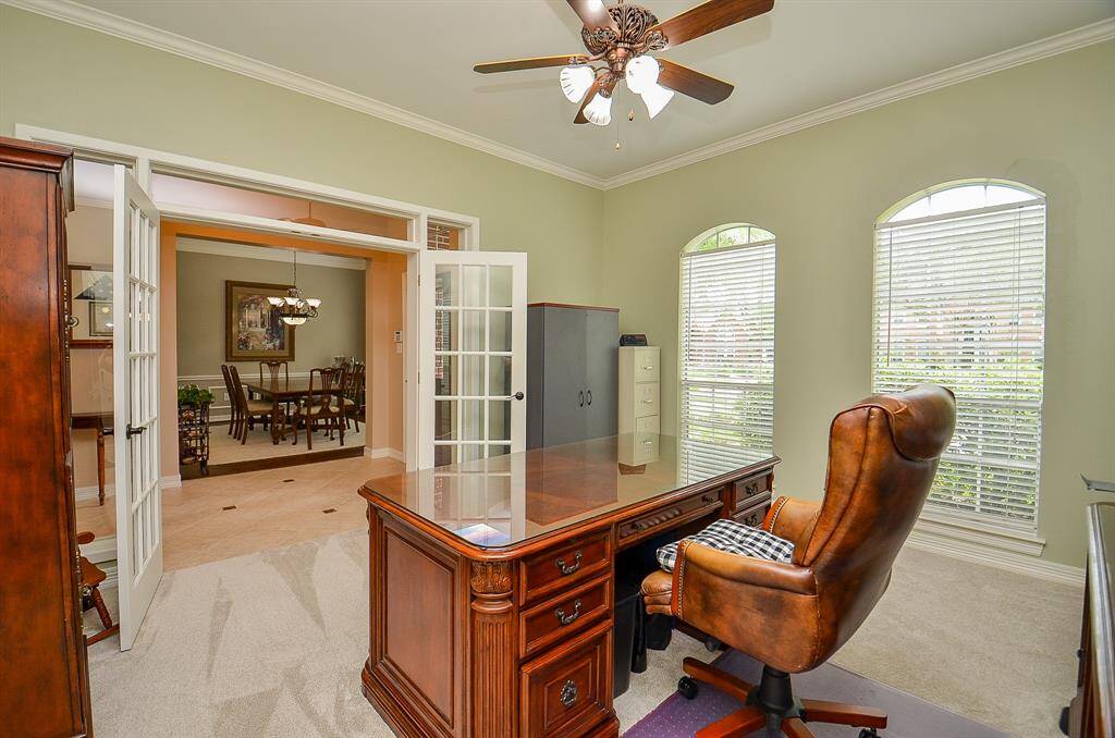 Front rooms are right off the main entrance foyer; starting with this gorgeous home office/study space, with huge arched windows, carpeting and classic french doors offering privacy, if desired. Opposite, is the stunning formal dining space.