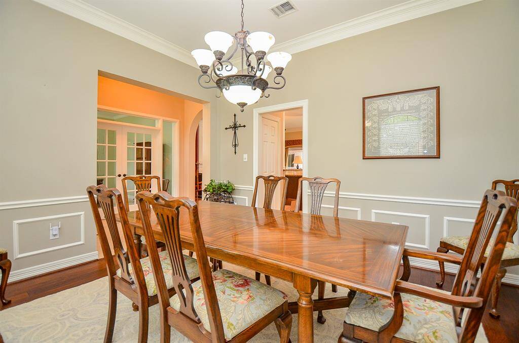 There's plenty of space for large dining pieces and accents, with the kitchen through  the doorway, up center.