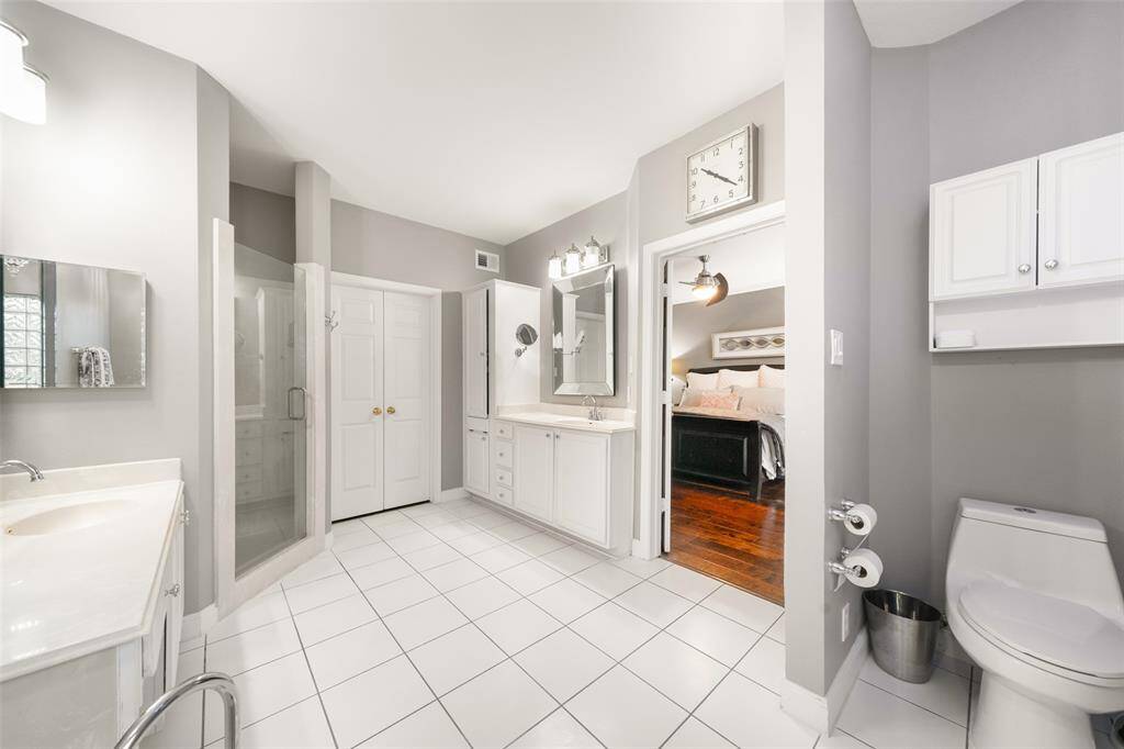 In addition to the double vanities and good-sized shower, the primary bathroom's walk-in closet, which is located next to the shower, offers terrific storage.