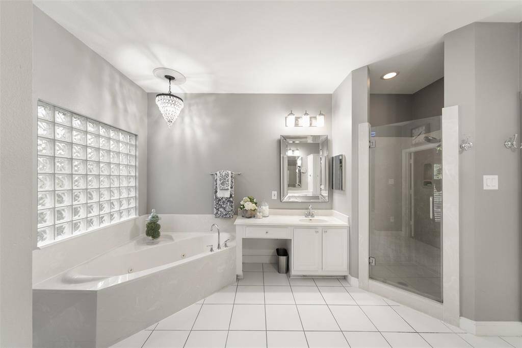 This well-designed primary bathroom has both a large tub for a relaxing soak and a refreshing, walk-in shower.