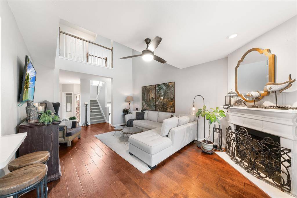Up to the second floor living room, the beautiful hardwoods continue!  The soaring ceilings and cast stone fireplace add to this room's tremendous appeal.