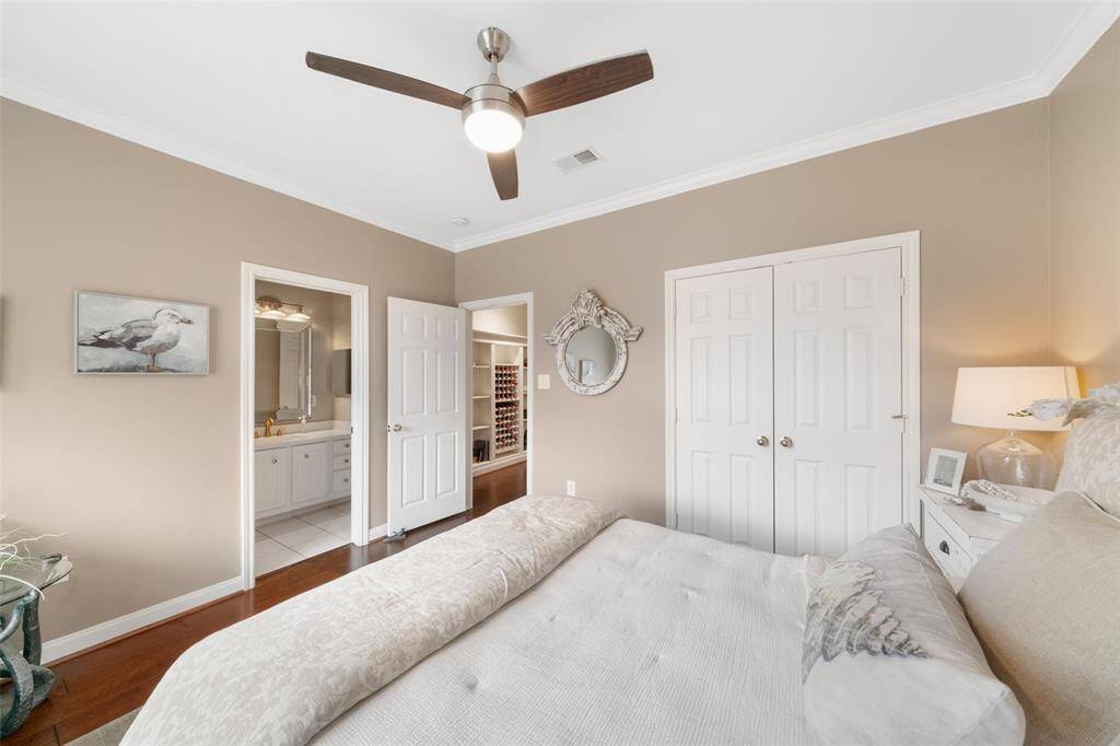 Seen from this angle of the second bedroom are the double-door closet and the adjoining bathroom.
