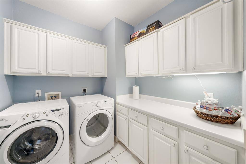 The laundry room is fully appointed with lots of cabinets, drawers and ample counterspace.