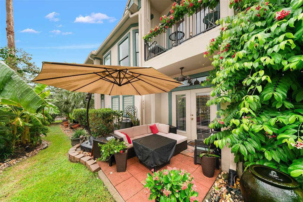 The back patio is a cozy and shady spot for relaxing.