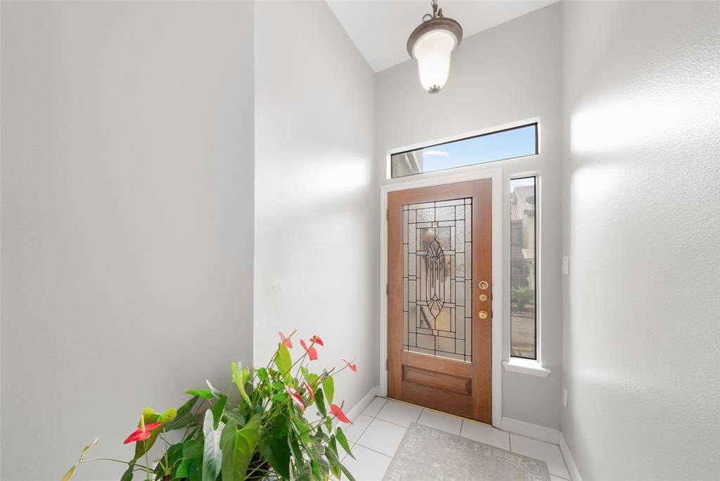 Step inside and look back to see the striking lead-glass front door with a transom window and a side light window that both let in so much natural light.