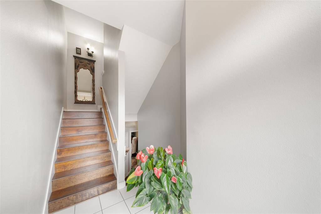 As you enter the townhome, there's a split staircase. The hardwood flooring on the stair case that starts here and continues throughout much of the house is rich and gleaming.
