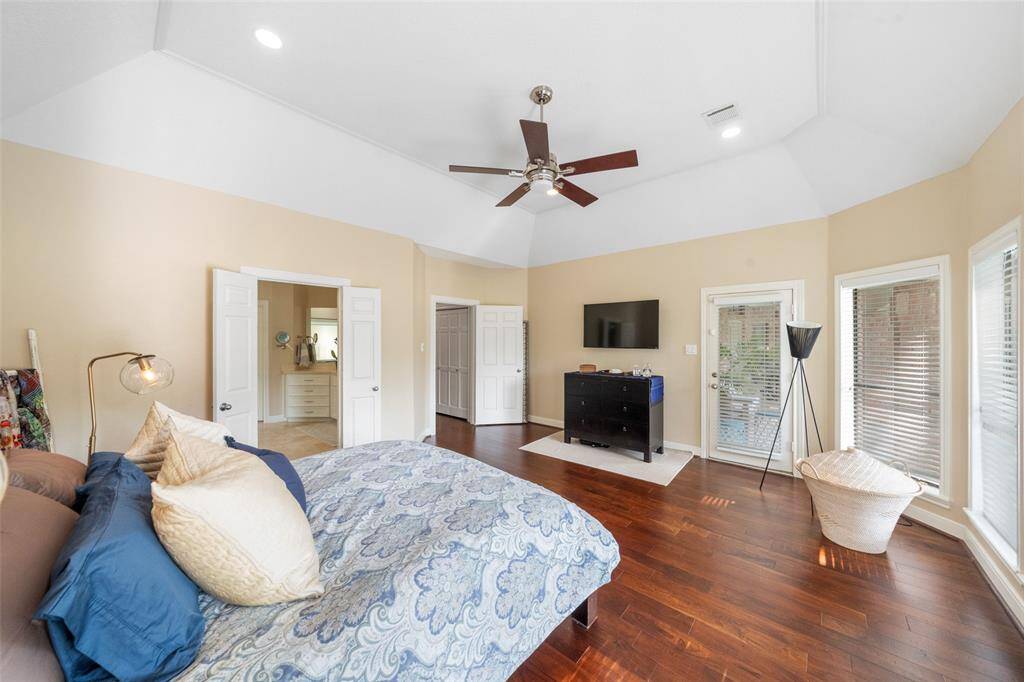 The primary bedroom has a separate door leading to the beautiful veranda and lush garden and pool.