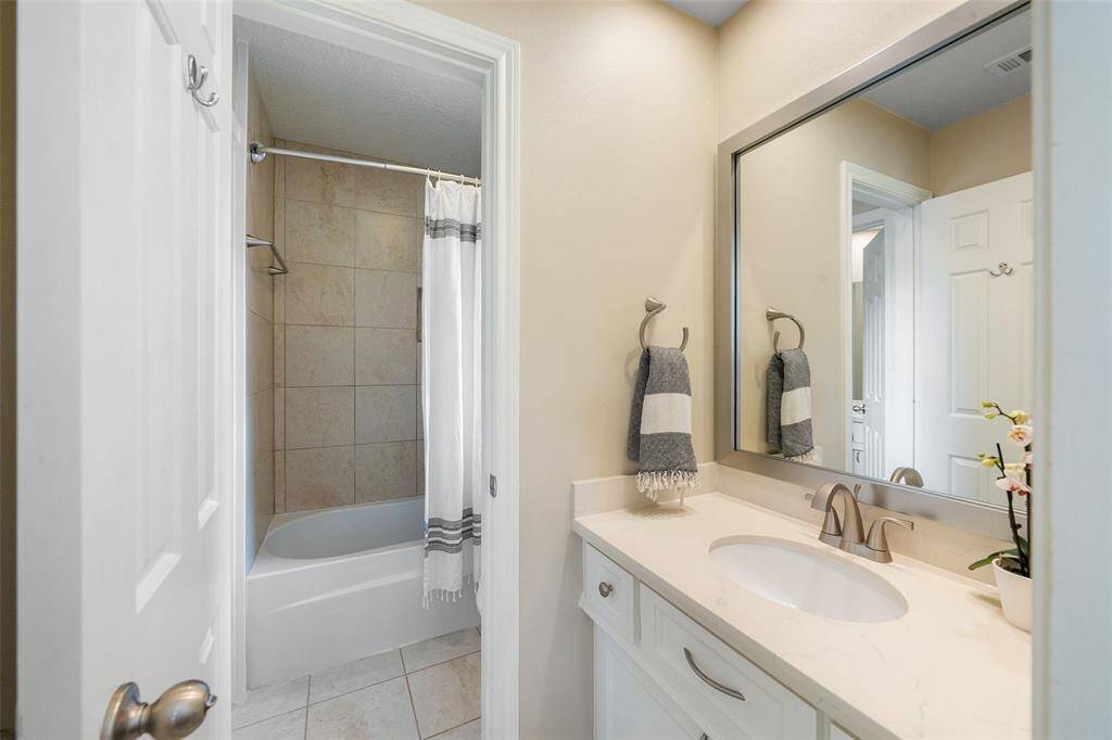 Jack and Jill bathroom with separate vanities.