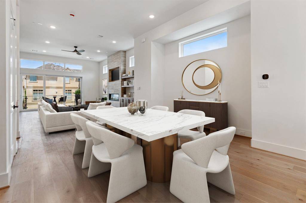 The dining room seamlessly connects the kitchen and living areas, perfect for entertaining in this open-concept space. Features a charming alcove (perfect for a buffet or console table) with a window and pre-wired outlet for a future light fixture. Note: this photo has been virtually staged.