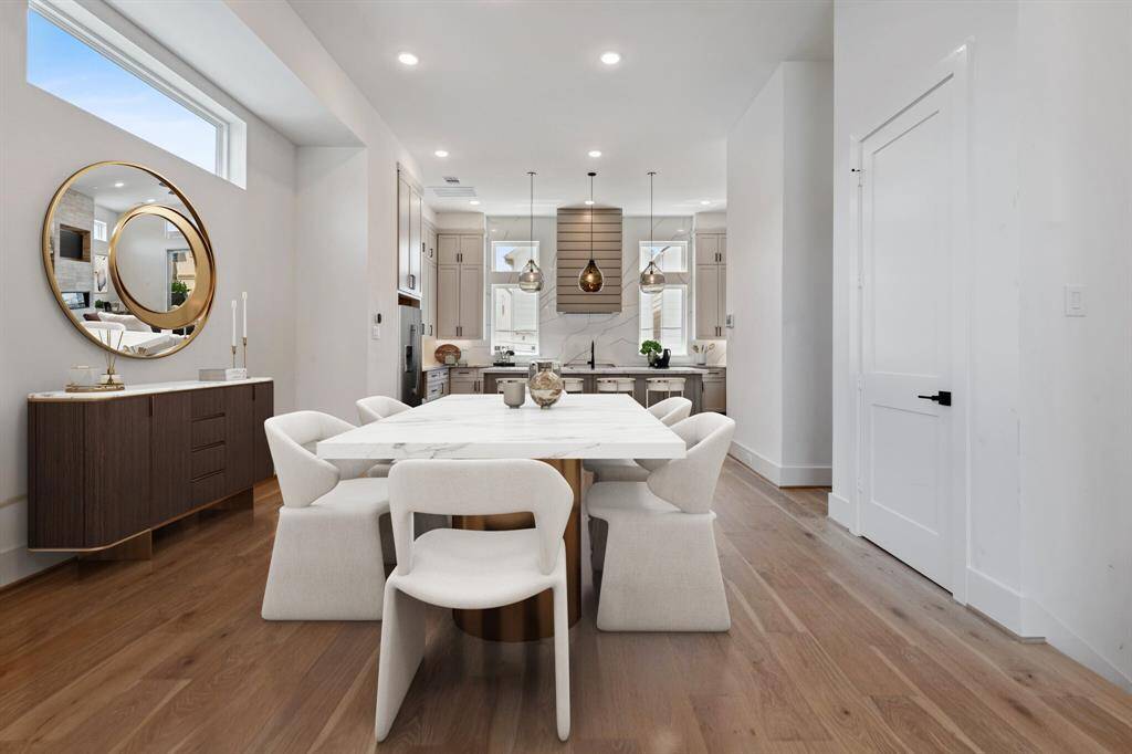 Another view of this wonderful formal dining room, built for entertaining. To the right is a hallway to the stylish half bath. The door to the right opens to the elevator ready shaft which currently serves as an oversized storage closet.  Note: this photo has been virtually staged.