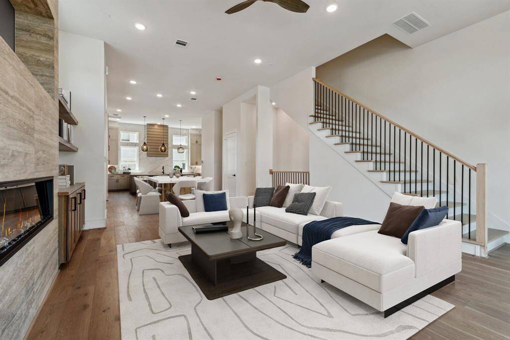 Another view of this incredible living room showing the seamless flow with the kitchen and dining areas; perfect for entertaining & everyday living. Note: this photo has been virtually staged.