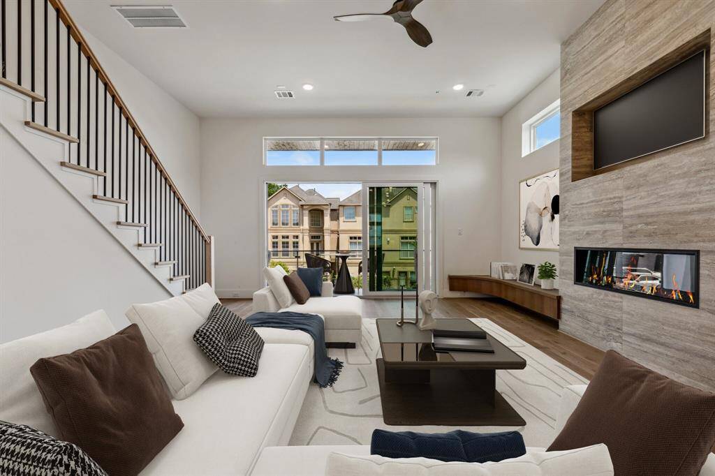 A look back towards the living room with Ply Gym 3-panel sliding doors opening to a large balcony. Fabulous indoor/outdoor living! Note: this photo has been virtually staged.