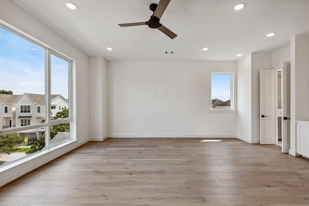Another view of this light and bright primary suite. Just before you enter the primary bathroom, there is a built-in nook that offers the perfect spot for a coffee bar or extra storage. From the right window, you have the perfect view of Downtown! Expansive room offers space for a sitting area!