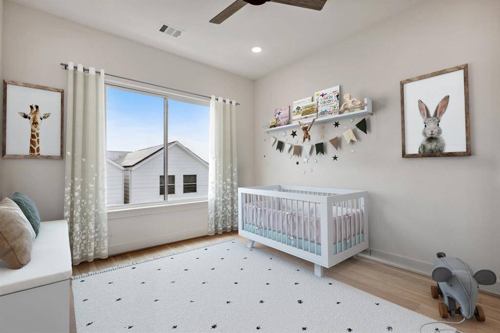 Located on the third floor alongside the primary suite, this spacious secondary bedroom #1 boasts upgraded oversized windows with stunning views of the Galleria and Downtown. Features a Visual Comfort ceiling fan and pre-wired for a future TV, it’s the perfect blend of comfort and convenience. Note: this photo has been virtually staged.
