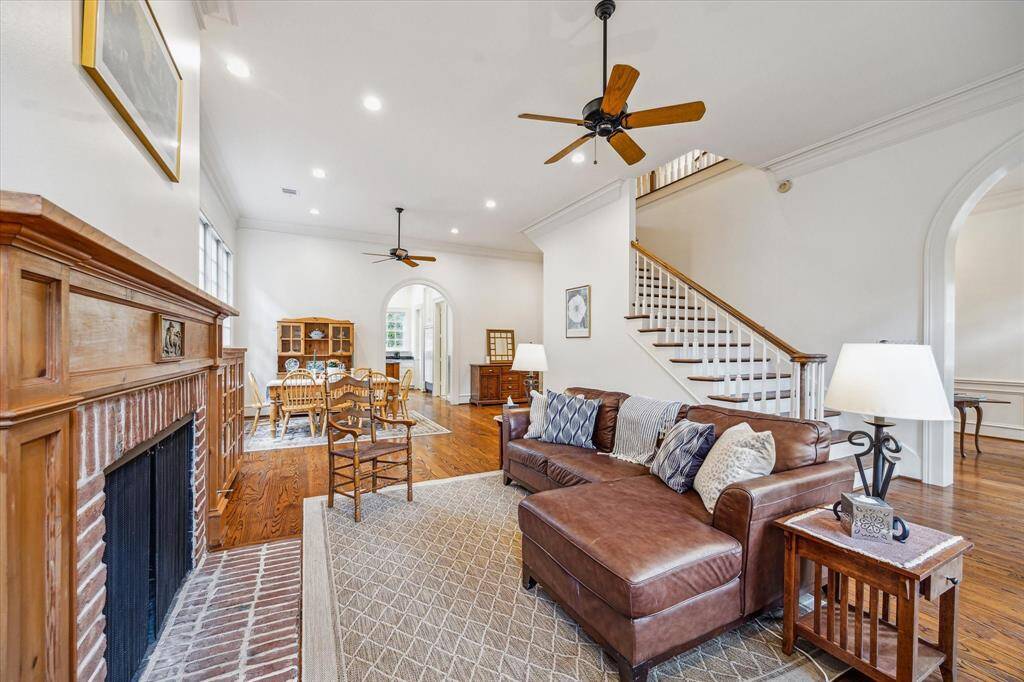 A striking fireplace with rich brick and custom millwork anchors the living space, adding rustic warmth and timeless character to this inviting room.