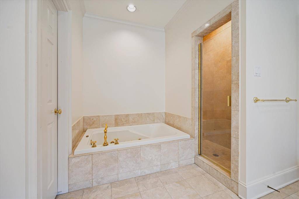 Separate soaking tub to enjoy in your spa like primary bathroom alongside a walk-in shower.