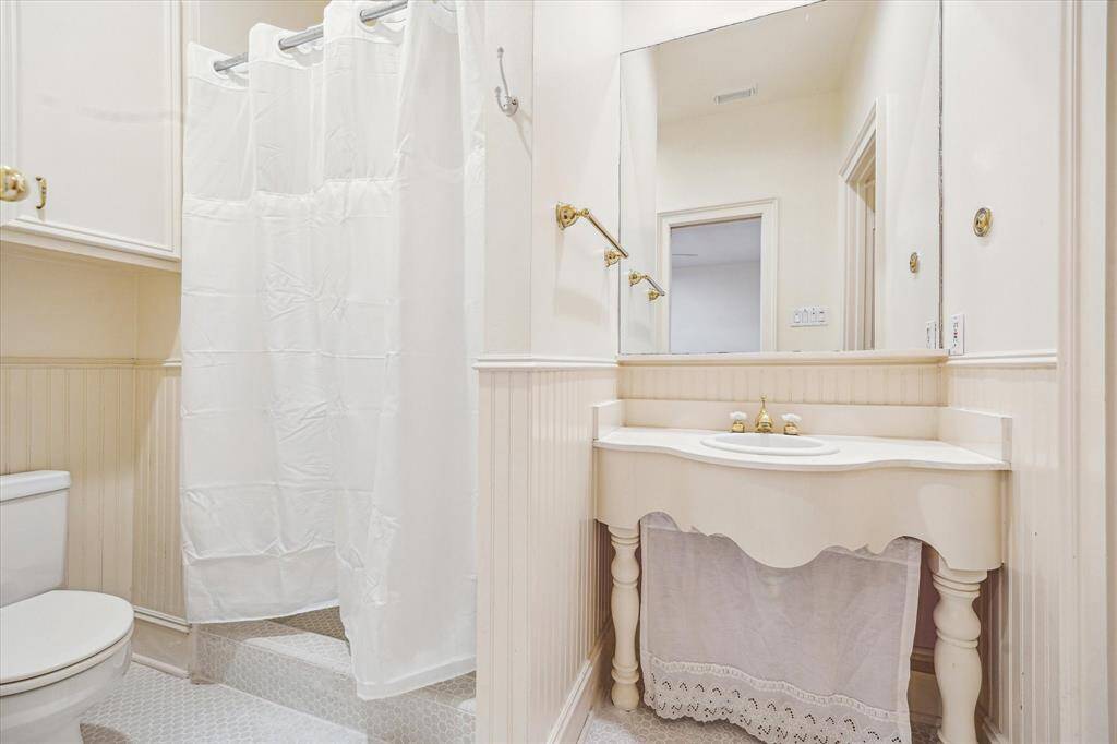 Additional secondary bathroom with shower only and private vanity area.