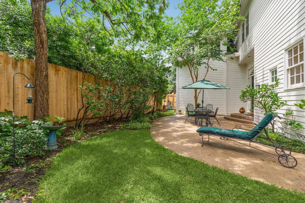 Room for a pool! The serene backyard oasis features a spacious patio surrounded by lush landscaping and mature trees, perfect for al fresco dining or lounging in the shade. With privacy fencing and peaceful garden accents, it’s an ideal retreat for quiet mornings or relaxed entertaining.