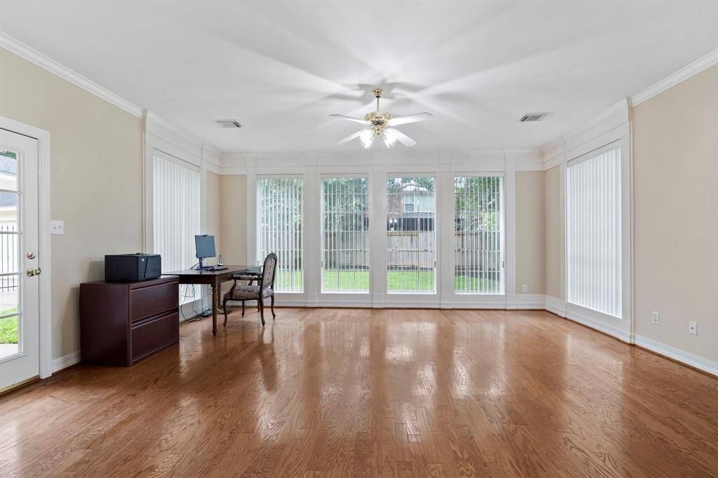 A highlight of the home is the stunning sunroom, surrounded by windows and complete with a separate entrance, offering a perfect space for a home office, studio, or reading retreat.