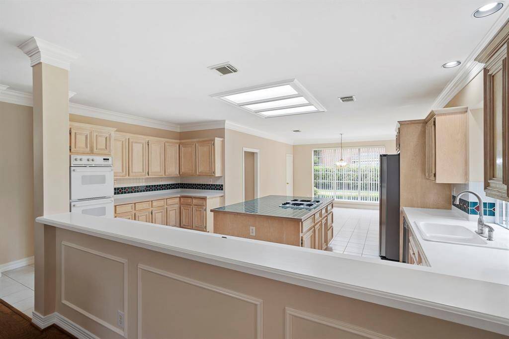 A functional pony wall subtly connects the kitchen and family room, creating an open yet defined layout that's perfect for entertaining and everyday living.