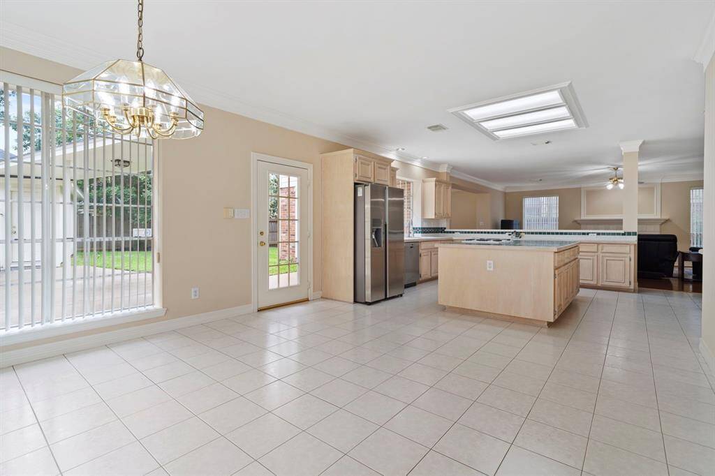 This spacious open-concept kitchen and breakfast area is the heart of the home.