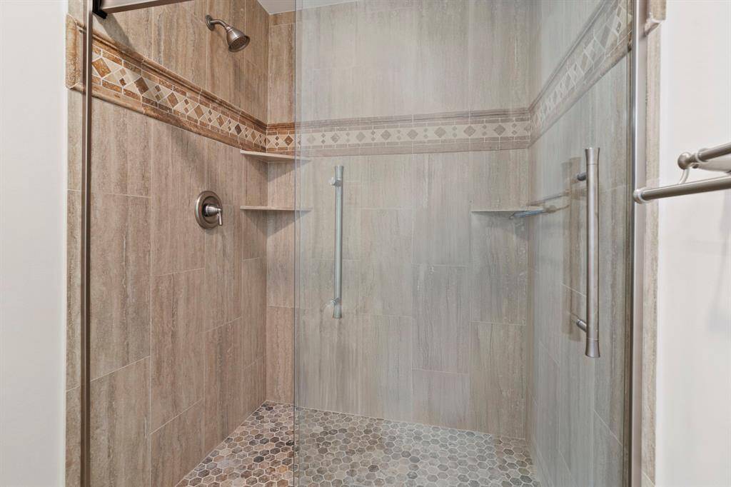 Renovated in July 2023, this sleek glass walk-in shower features contemporary finishes and a spa-inspired design.
