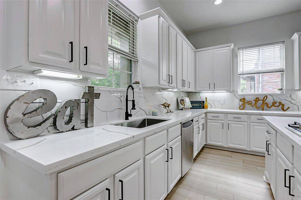 Fresh paint, lighting, and flooring throughout create a bright, airy atmosphere with sleek black accents adding the perfect modern contrast.