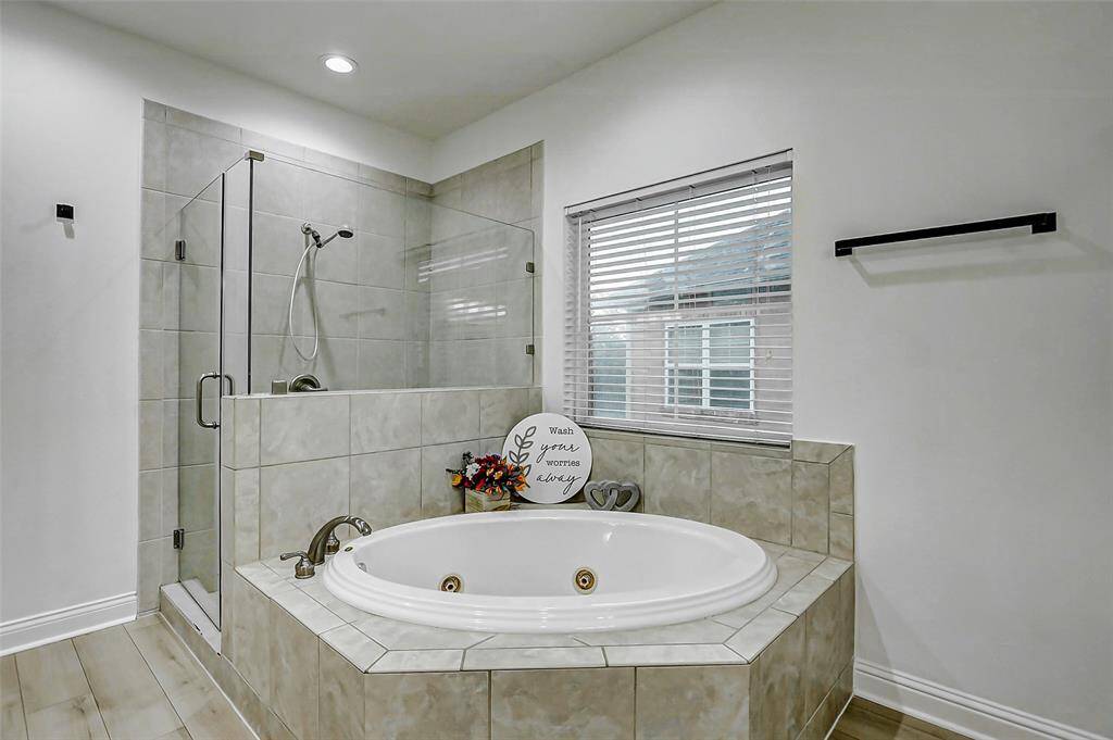 The en-suite bath feels like a spa with its separate soaking tub and shower, dual vanities, and room to truly spread out and unwind.