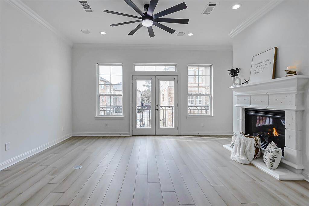 The open-concept living room seamlessly flows into the kitchen and dining areas, creating the ideal layout for entertaining and everyday life