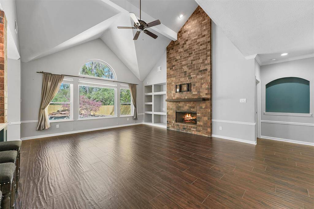 Family room.  The fireplace has gas logs, beautiful ceiling and the large windows looking out to the pool.