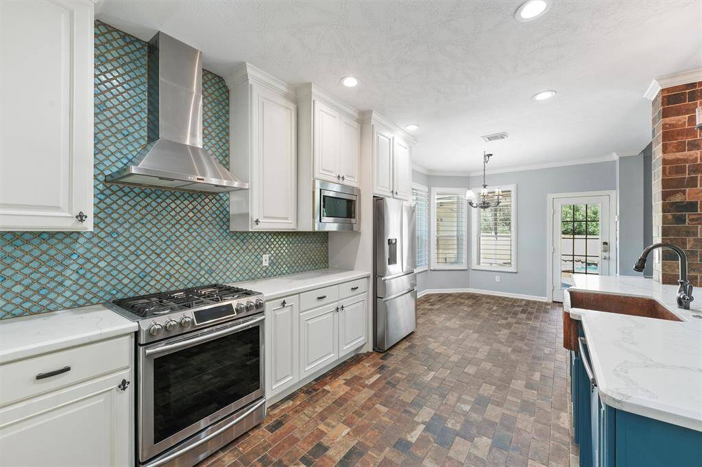 Gas range and beautiful back splash.